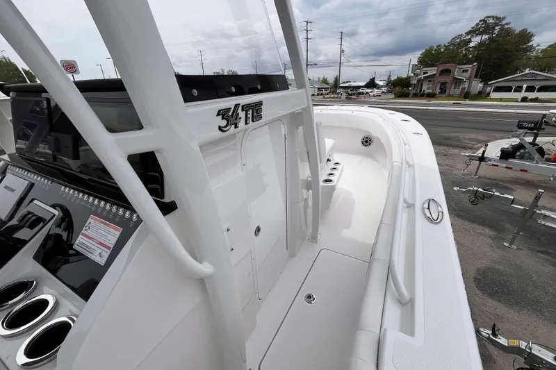 Slide: The Image of 2025 Fountain 34 Tournament Edition boat, sleek design, white interior, parked outdoors. - 12