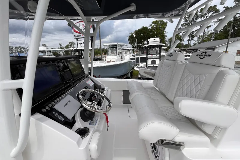 Slide: The Image of 2025 Fountain 34 Tournament Edition boat interior with white seating and modern dashboard. - 17