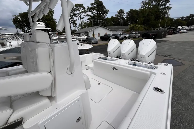 Slide: The Image of 2025 Fountain 34 Tournament Edition boat with triple Mercury engines, parked outdoors. - 18