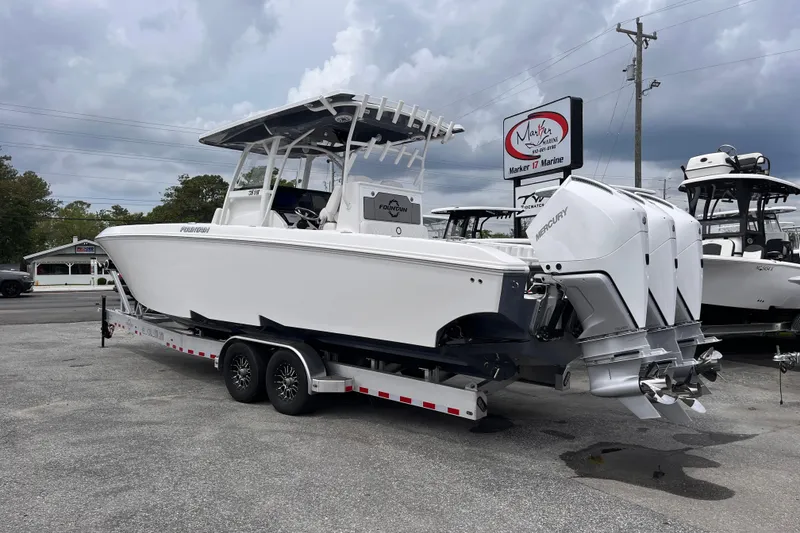 Slide: The Image of 2025 Fountain 34 Tournament Edition boat on trailer, displayed at Marker 17 Marine dealership. - 3