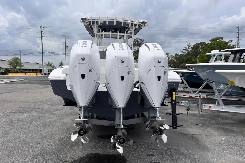 Slide: The Image of 2025 Fountain 34 Tournament Edition boat with triple outboard engines, parked on a trailer. - 4