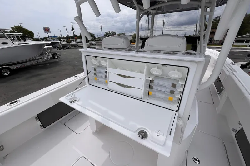 Slide: The Image of 2025 Fountain 34 Tournament Edition boat with open storage compartments and seating. - 9