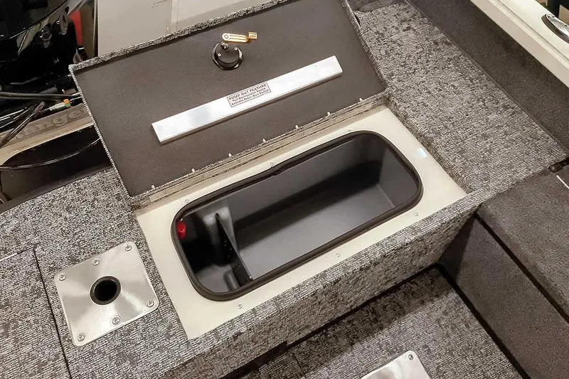 Slide: The Image of 2026 Ranger VS1682SC Angler boat storage compartment with open lid and textured interior. - 25