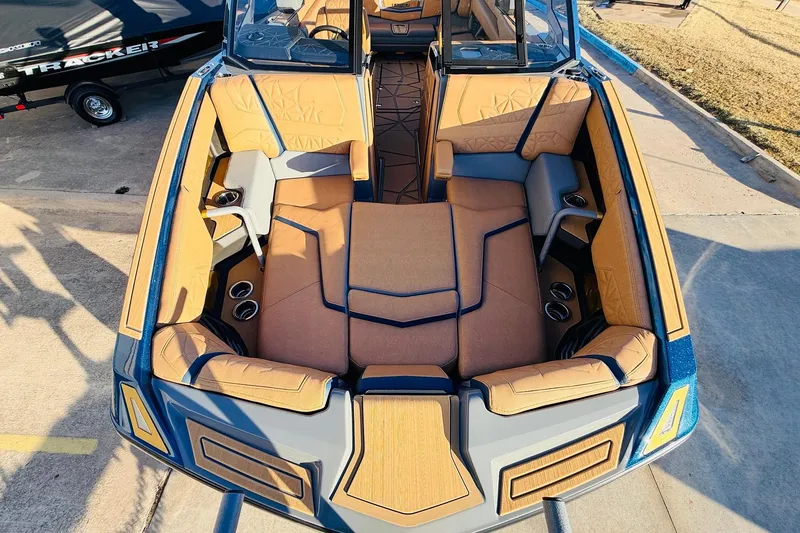 Slide: The Image of 2026 Nautique Super Air Nautique G25 Paragon boat interior with luxurious seating and cup holders. - 19
