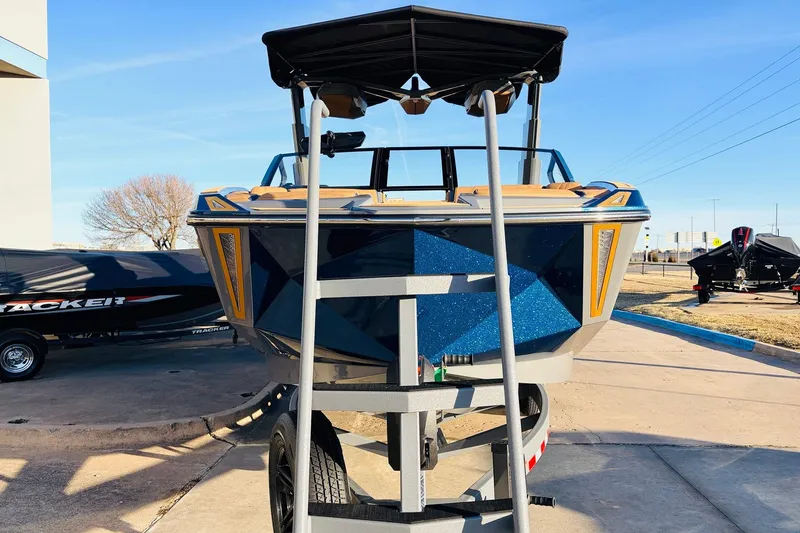 Slide: The Image of 2026 Nautique Super Air Nautique G25 Paragon boat on trailer, front view. - 3