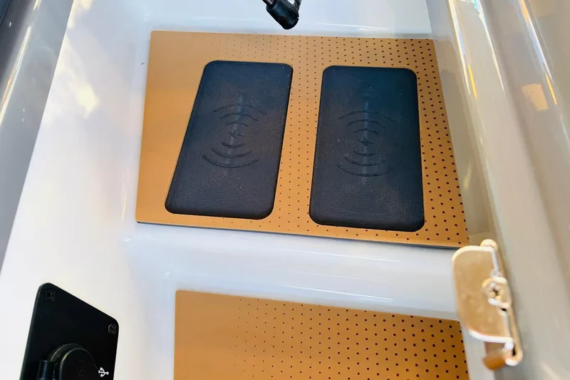 Slide: The Image of Interior view of 2026 Nautique Super Air Nautique G25 Paragon with wireless charging pads. - 41