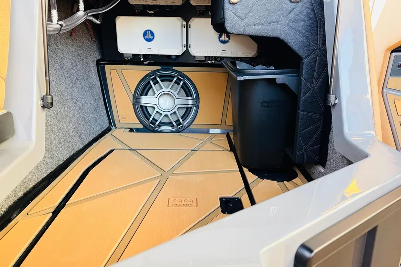 Slide: The Image of 2026 Nautique Super Air Nautique G25 Paragon interior with speaker and storage. - 44