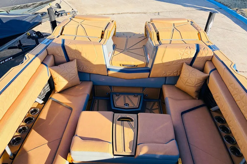 Slide: The Image of Luxurious interior of 2026 Nautique Super Air Nautique G25 Paragon boat with tan upholstery. - 53
