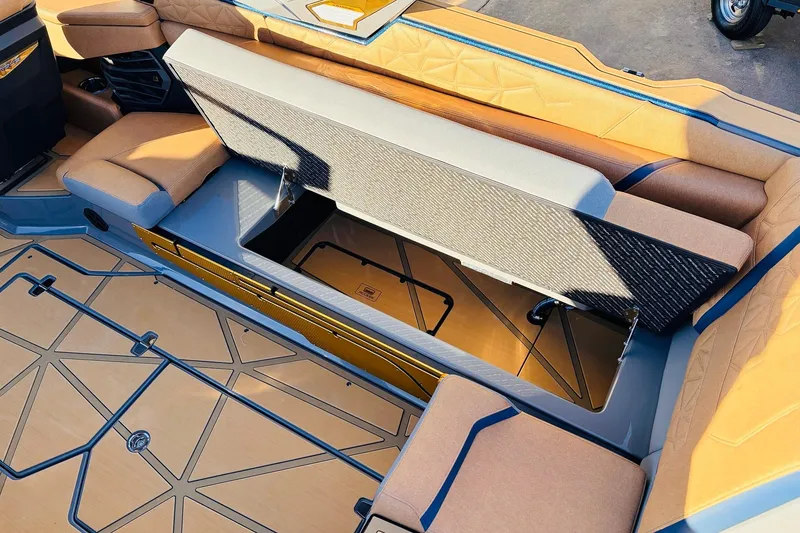 Slide: The Image of 2026 Nautique Super Air Nautique G25 Paragon interior storage compartment open, showcasing luxury seating. - 63