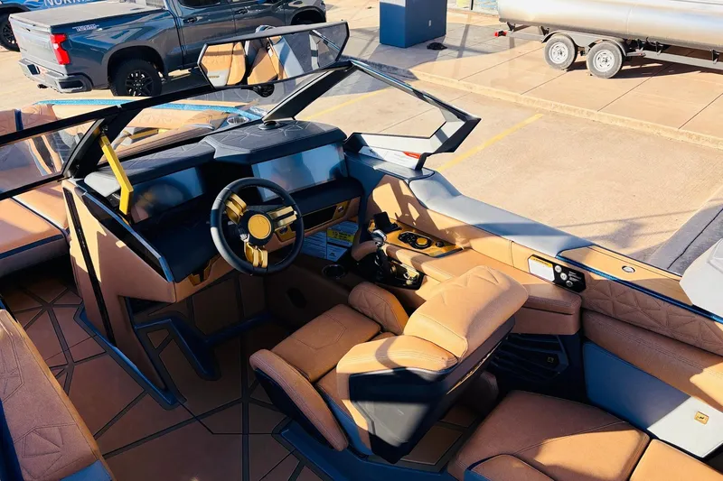 Slide: The Image of Interior of 2026 Nautique Super Air Nautique G25 Paragon boat with luxurious seating and modern dashboard. - 65
