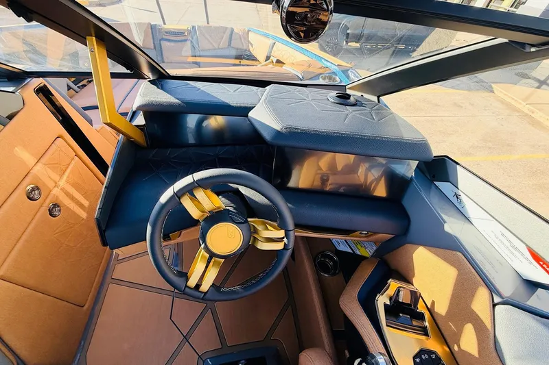 Slide: The Image of Interior of 2026 Nautique Super Air Nautique G25 Paragon, featuring luxurious steering and dashboard. - 68