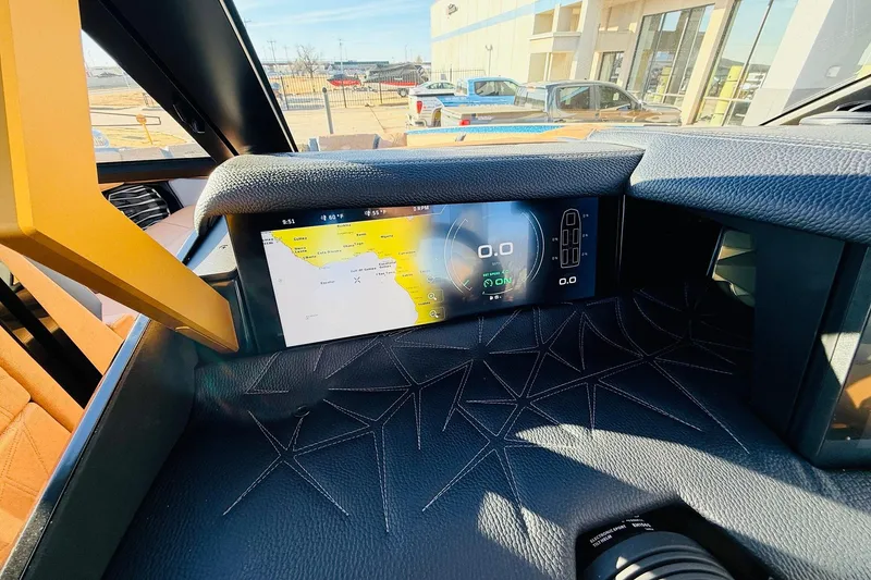 Slide: The Image of 2026 Nautique Super Air Nautique G25 Paragon dashboard with digital display and navigation system. - 69