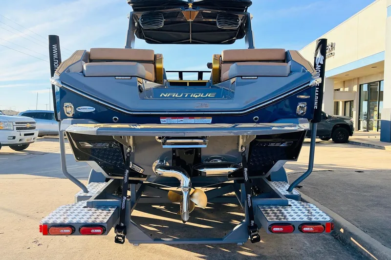 Slide: The Image of 2026 Nautique Super Air Nautique G25 Paragon boat rear view in a parking lot. - 7