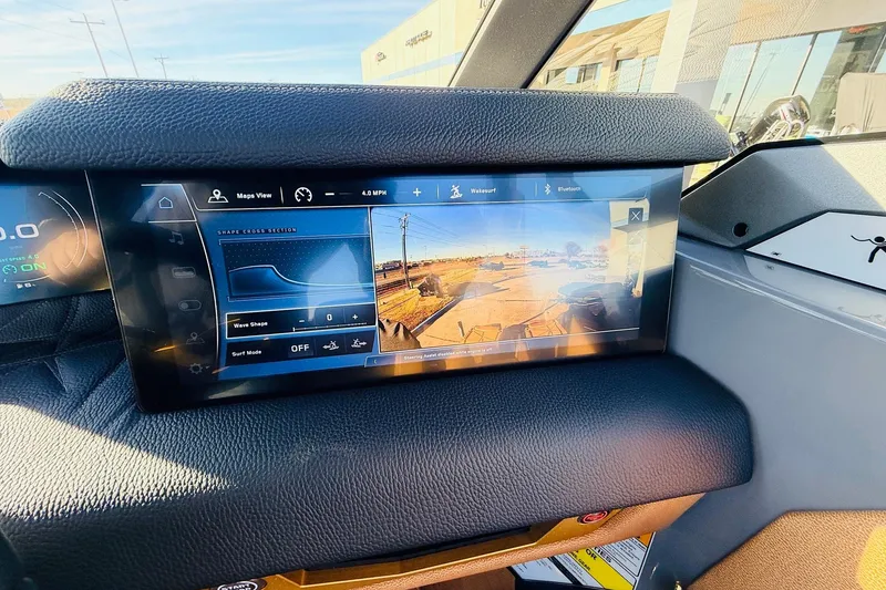 Slide: The Image of 2026 Nautique Super Air Nautique G25 Paragon dashboard with touchscreen display and controls. - 70