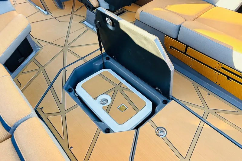Slide: The Image of 2026 Nautique Super Air Nautique G25 Paragon interior with open storage compartment. - 72