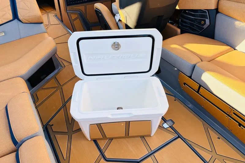 Slide: The Image of Open cooler on 2026 Nautique Super Air Nautique G25 Paragon boat interior. - 74