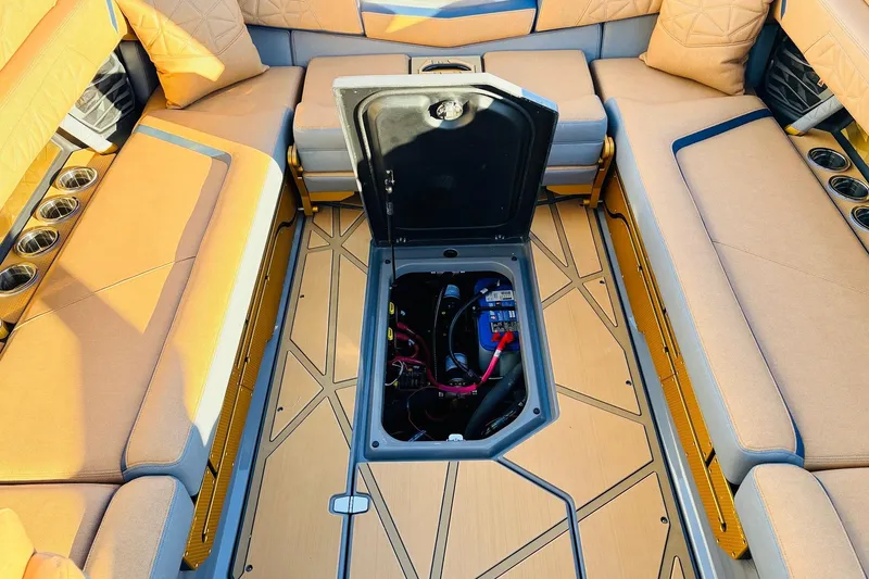 Slide: The Image of 2026 Nautique Super Air Nautique G25 Paragon interior with open storage compartment. - 75