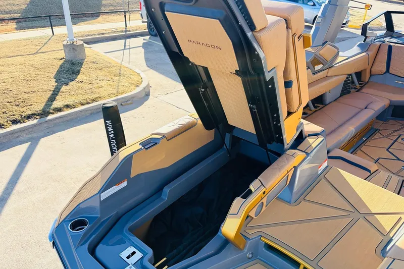 Slide: The Image of 2026 Nautique Super Air Nautique G25 Paragon interior with open storage compartment. - 85
