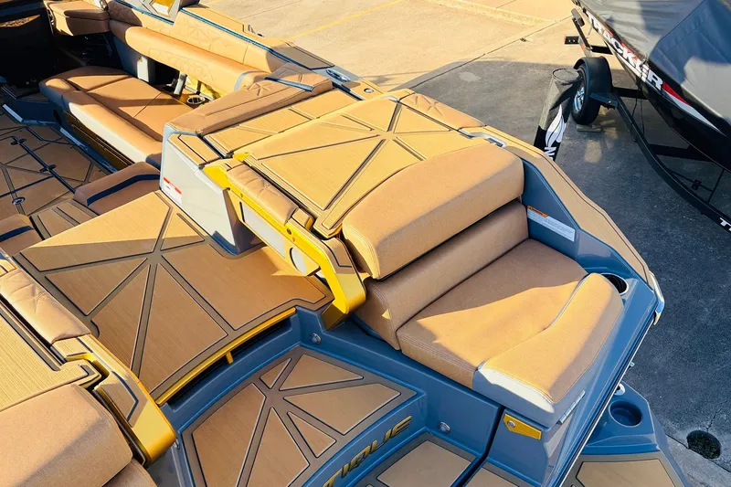 Slide: The Image of 2026 Nautique Super Air Nautique G25 Paragon boat interior with tan seating and deck. - 86