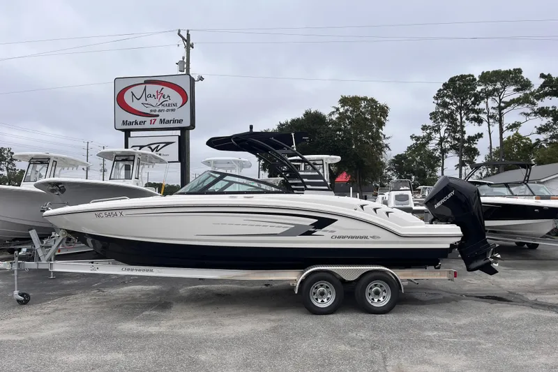 The Image of 2025 Chaparral 23 SSi OB boat on trailer at dealership, overcast day. - 0
