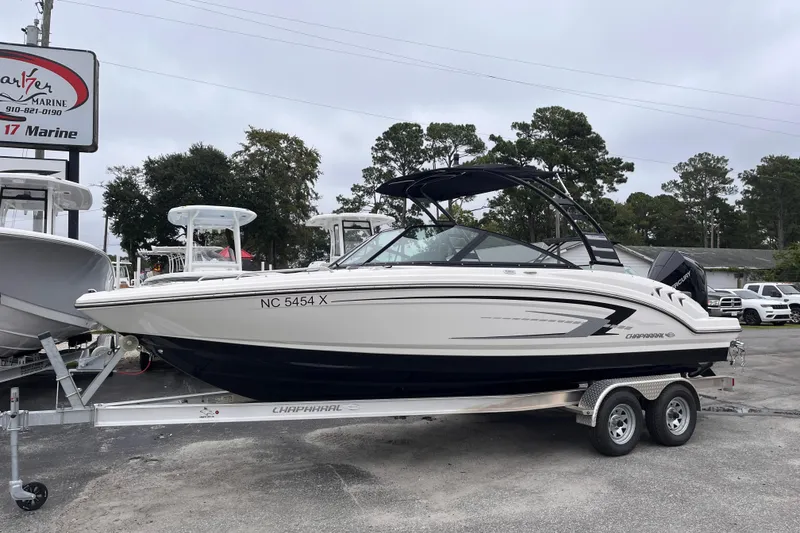 Slide: The Image of 2025 Chaparral 23 SSi OB boat on trailer at dealership, side view. - 1