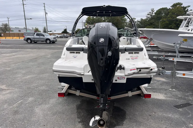 Slide: The Image of 2025 Chaparral 23 SSi OB boat with powerful outboard motor, parked on trailer. - 2