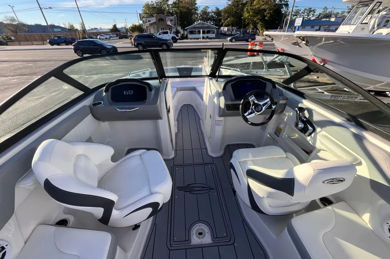 Slide: The Image of 2025 Chaparral 23 SSi OB boat interior with modern seating and steering wheel. - 6
