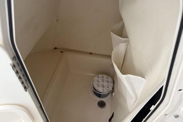 Slide: The Image of 2020 Pioneer 202 Islander boat storage compartment with drain and storage pockets. - 6