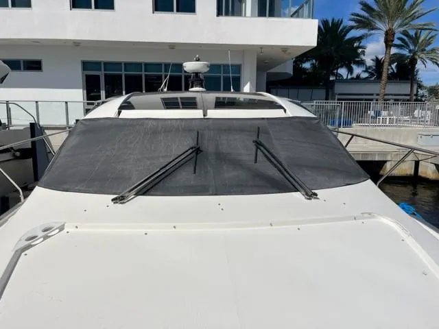 Slide: The Image of 2008 Marquis 40 SC yacht docked near a modern building. - 10