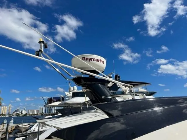 Slide: The Image of 2008 Marquis 40 SC yacht with Raymarine radar under a clear blue sky. - 11