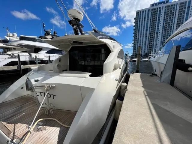 Slide: The Image of 2008 Marquis 40 SC yacht docked at marina with cityscape background. - 13