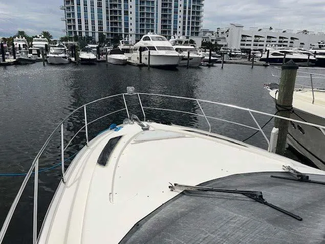 Slide: The Image of 2008 Marquis 40 SC yacht docked at a marina with other boats. - 14