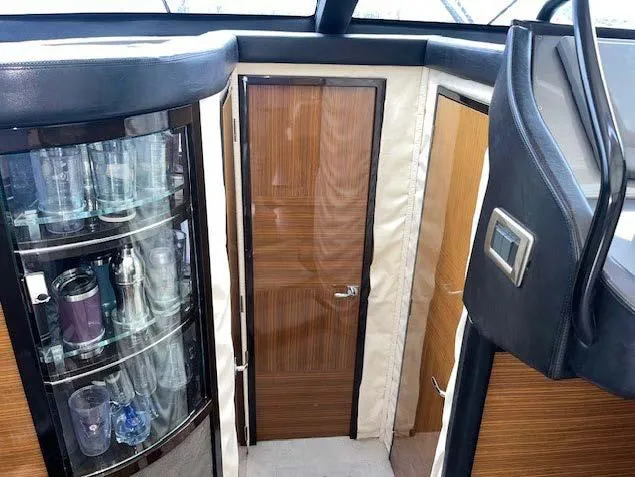 Slide: The Image of Interior of 2008 Marquis 40 SC yacht with glass cabinet and wooden door. - 17