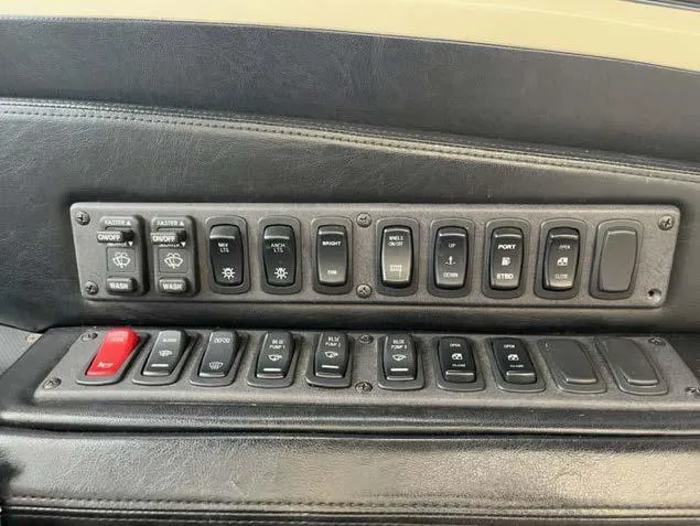 Slide: The Image of Control panel of a 2008 Marquis 40 SC yacht with various switches and buttons. - 19