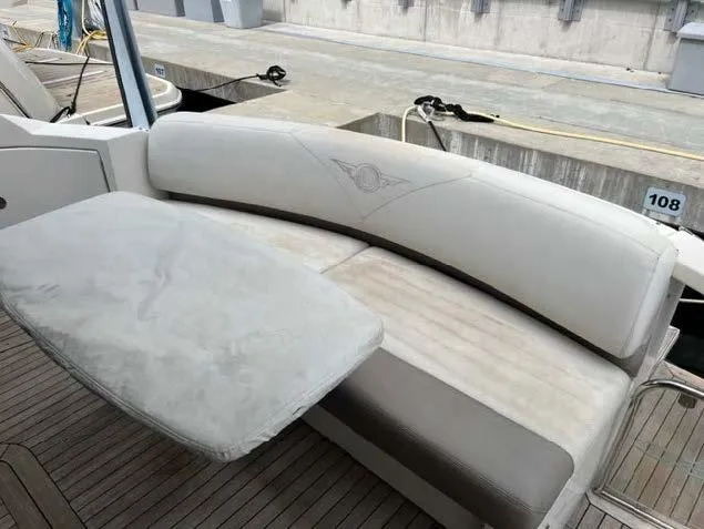 Slide: The Image of 2008 Marquis 40 SC yacht interior seating area with white upholstery and table. - 25