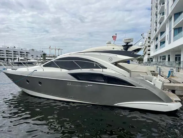 Slide: The Image of 2008 Marquis 40 SC yacht docked at a marina. - 34