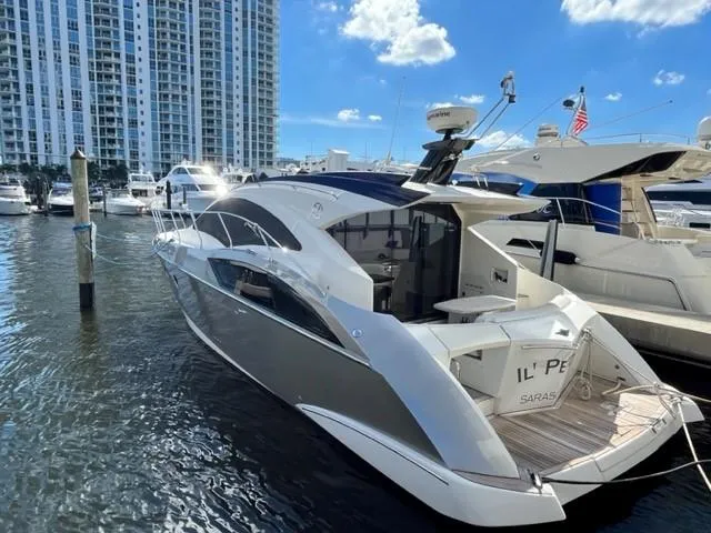 Slide: The Image of 2008 Marquis 40 SC yacht docked at marina with cityscape background. - 4