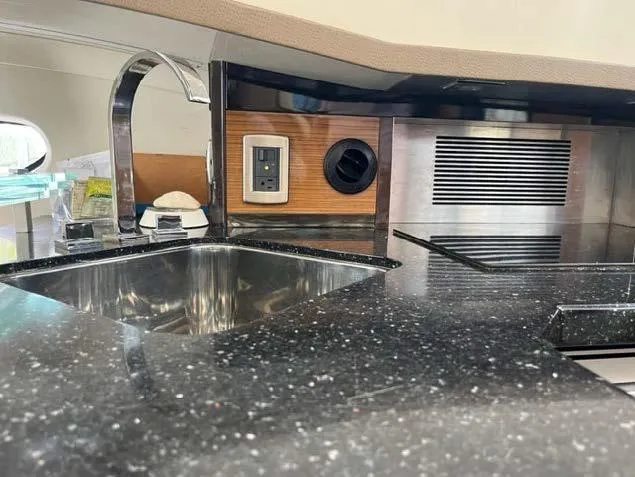 Slide: The Image of 2008 Marquis 40 SC yacht kitchen with black granite countertop and stainless steel sink. - 41