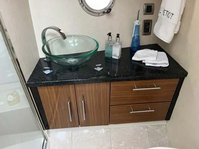 Slide: The Image of Modern bathroom vanity in 2008 Marquis 40 SC yacht with glass sink and wooden cabinets. - 49