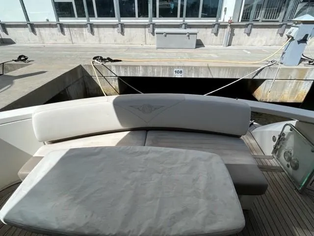 Slide: The Image of 2008 Marquis 40 SC yacht with cushioned seating at the dock. - 8