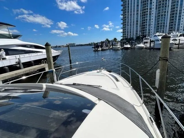 Slide: The Image of 2008 Marquis 40 SC yacht docked at a marina with high-rise buildings in the background. - 9