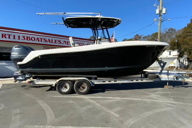 The Image of 2020 Aquasport 2500 Center Console boat on trailer at dealership. - 1