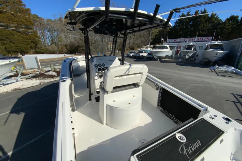 Slide: The Image of 2020 Aquasport 2500 Center Console boat at dealership, showcasing helm and seating area. - 10