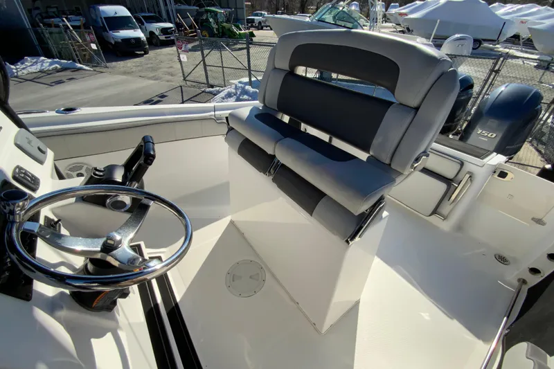 Slide: The Image of 2020 Aquasport 2500 Center Console boat interior with steering wheel and seating. - 13