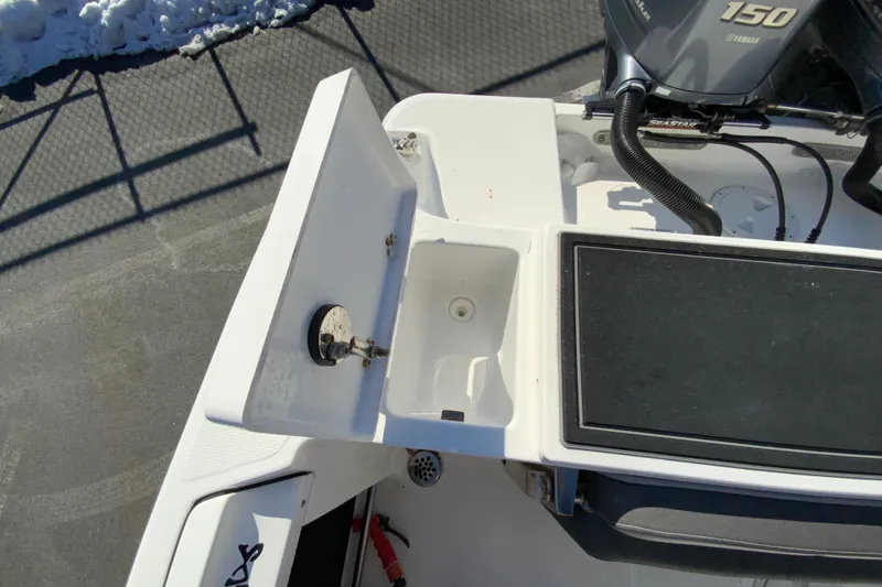 Slide: The Image of 2020 Aquasport 2500 Center Console boat with open storage compartment and Yamaha 150 engine. - 17