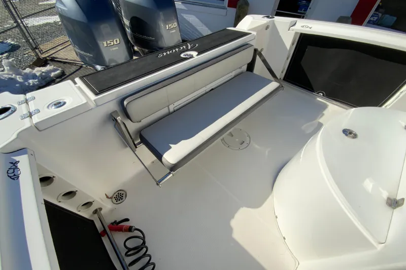 Slide: The Image of 2020 Aquasport 2500 Center Console boat interior with foldable seating and twin 150 engines. - 18
