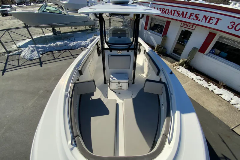 Slide: The Image of 2020 Aquasport 2500 Center Console boat at dealership, snowy surroundings. - 25