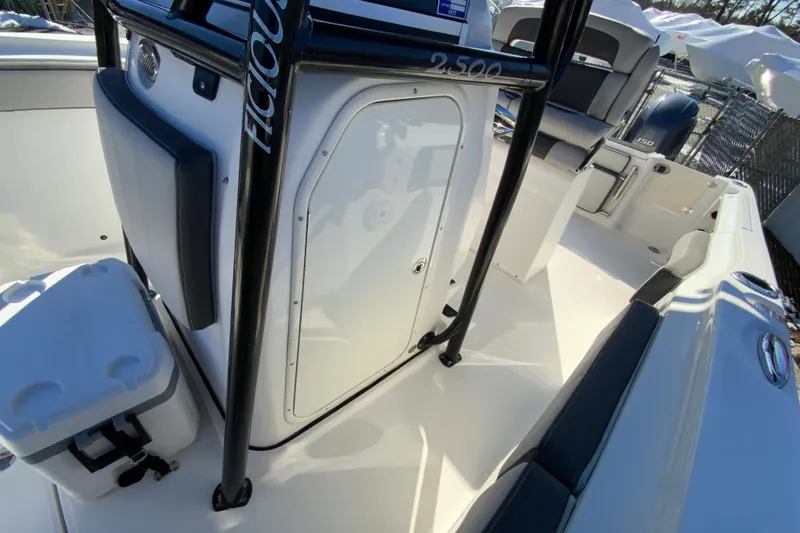 Slide: The Image of 2020 Aquasport 2500 Center Console boat interior with seating and storage. - 26