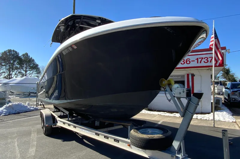 Slide: The Image of 2020 Aquasport 2500 Center Console boat on trailer, parked outdoors. - 3