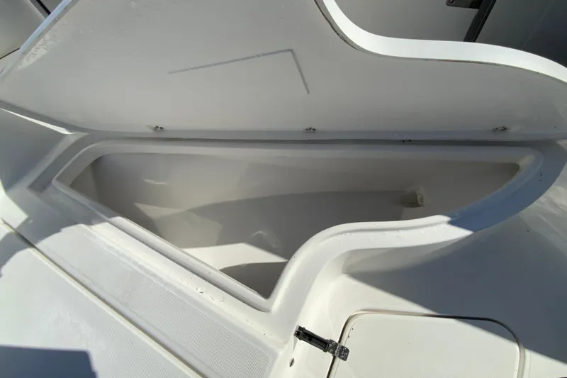 Slide: The Image of Open storage compartment on 2020 Aquasport 2500 Center Console boat. - 31